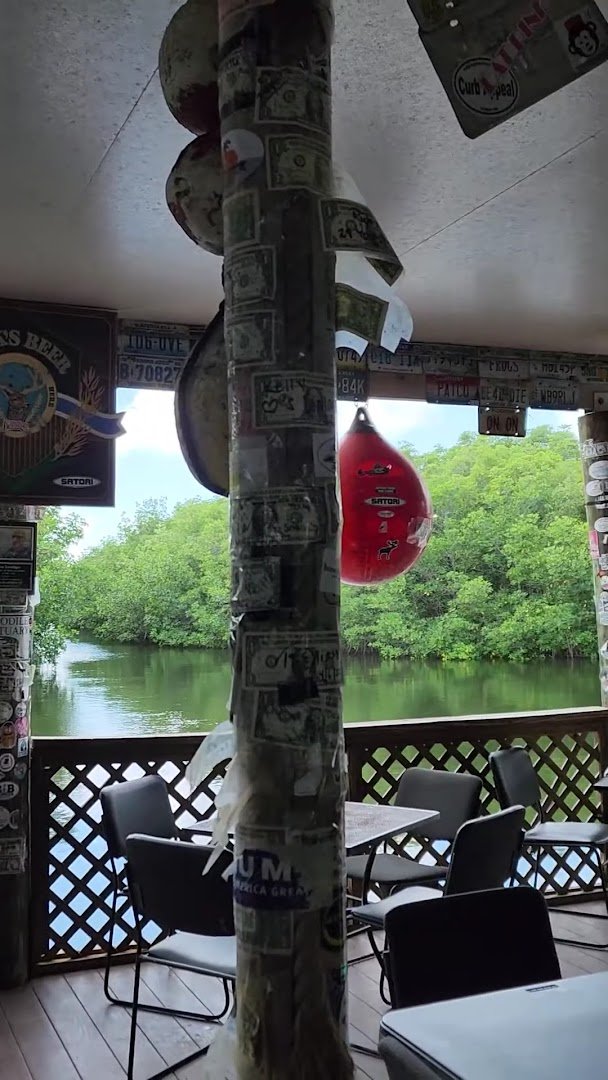 Waterside seafood restaurant with outdoor seating.